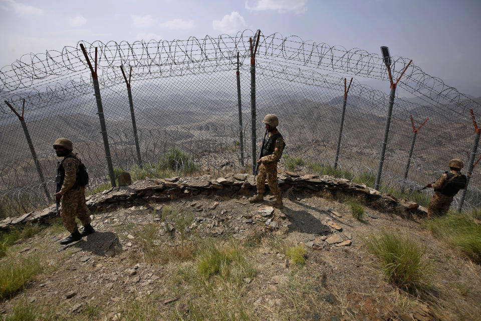 FILE - Pakistan Army troops patrol along the fence on the Pakistan Afghanistan border at Big Ben hilltop post in Khyber district, Pakistan, Aug. 3, 2021. The Afghan Taliban have shown no signs of expelling the Pakistani Taliban leaders or preventing them from carrying out attacks in Pakistan, even as Pakistan leads an effort to get a reluctant world to engage with Afghanistan’s new rulers and salvage the country from economic collapse. (AP Photo/Anjum Naveed, File)