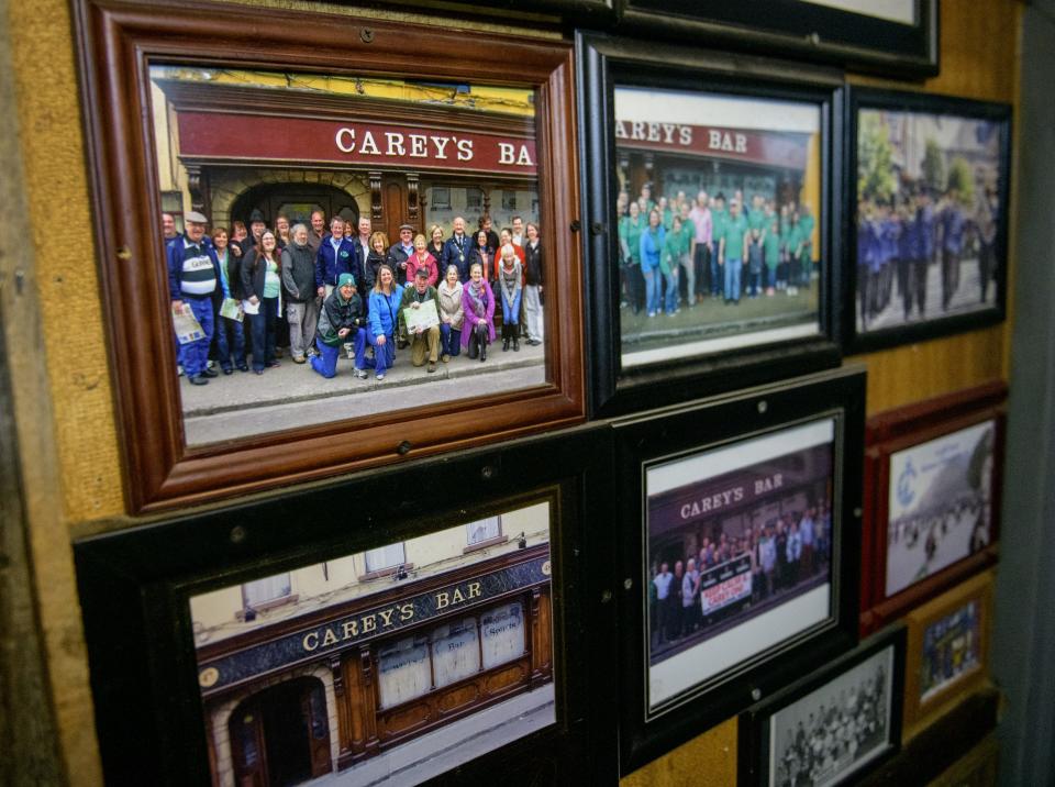 Photos from visits to Cary's Pub in Clonmel, Peoria's sister city in Ireland, hang on the wall at Jimmy's Bar on Farmington Road.