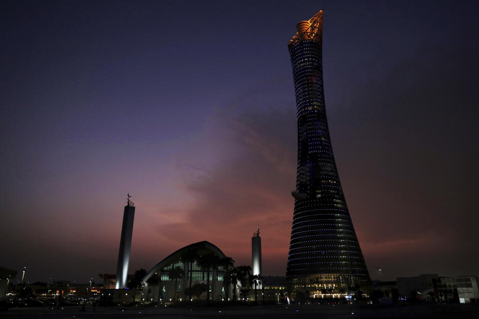 The sun sets behind the Khalifa International Stadium prior to the start of the World Athletics Championships in Doha, Qatar, Thursday, Sept. 26, 2019. (AP Photo/Nariman El-Mofty)