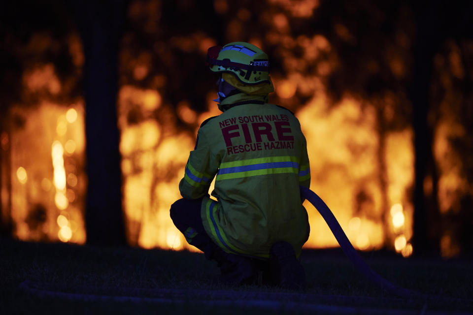 Fire crews wait at a property along Putty road as the fire front approaches on November 15, 2019 in Colo Heights, Australia. The warning has been issued for a 80,000-hectare blaze at Gospers Mountain, which is burning in the direction of Colo Heights. An estimated million hectares of land has been burned by bushfire across Australia following catastrophic fire conditions - the highest possible level of bushfire danger - in the past week. A state of emergency was declared by NSW Premier Gladys Berejiklian on Monday 11 November and is still in effect, giving emergency powers to Rural Fire Service Commissioner Shane Fitzsimmons and prohibiting fires across the state. Four people have died following the bushfires in NSW this week. (Photo by Brett Hemmings/Getty Images)