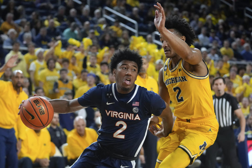 Virginia guard Reece Beekman (2) drives on Michigan guard Kobe Bufkin (2) in the first half of an NCAA college basketball game in Ann Arbor, Mich., Tuesday, Nov. 29, 2022. (AP Photo/Paul Sancya)