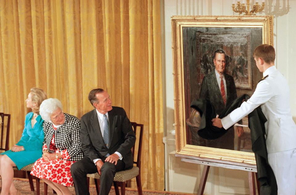 Former President George H.W. Bush and wife Barbara Bush look as his formal portrait is officially unveiled at the Whites House on July 17, 1995. The Bushes' returned to the White House for the unveiling of both of their portraits which were done by Herbert E. Abrams of Warren, Conn.
