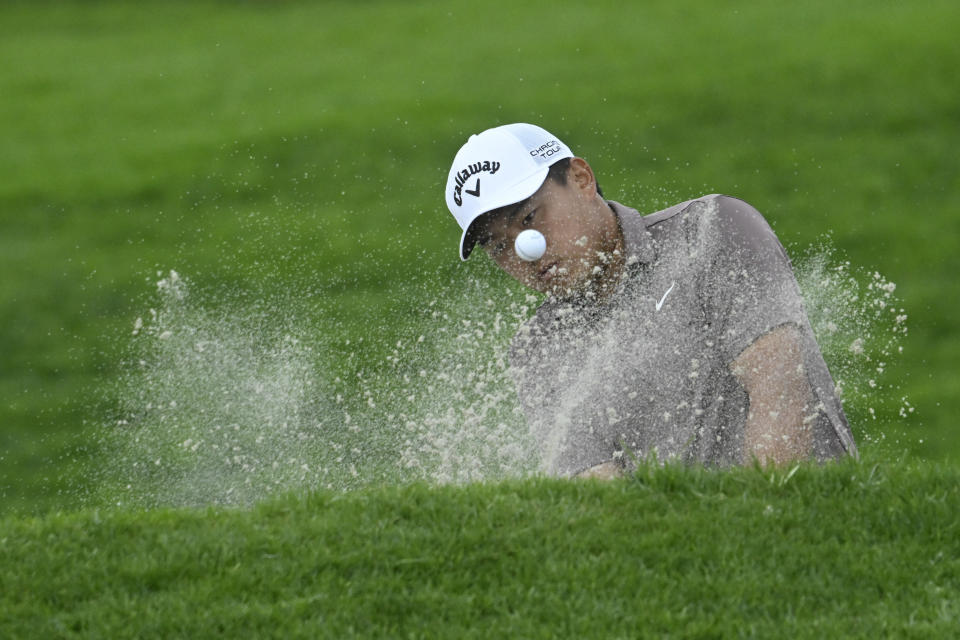 Kevin Yu hits out of bunker on the 18th hole of the North Course at Torrey Pines during the first round of the Farmers Insurance Open golf tournament, Wednesday, Jan. 24, 2024, in San Diego. (AP Photo/Denis Poroy)