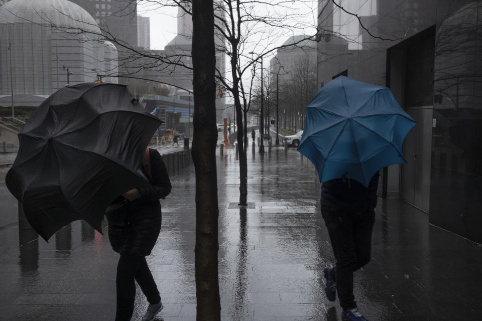 Pedestrians push their umbrellas against the wind as rain falls in downtown Manhattan in New York on Wednesday, April 3, 2024. More severe weather is coming across the nation. A major spring storm is expected to drop more than a foot of snow in parts of New England on Wednesday, while heavy rains are likely to soak the East Coast. (AP Photo/Patrick Sison)