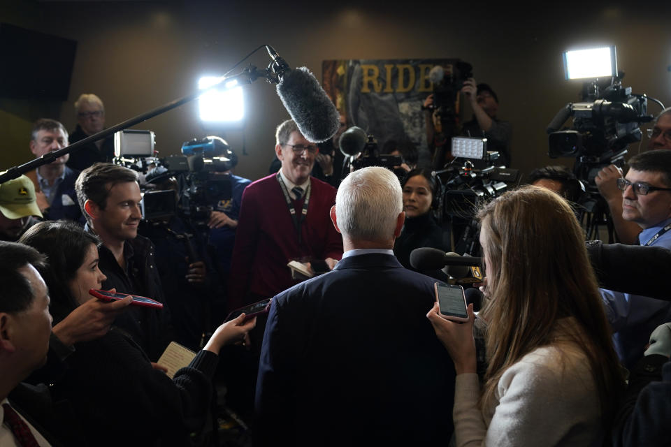 FILE - Former Vice President Mike Pence, center, talks to reporters after speaking at a parents rights rally on Feb. 15, 2023, in Cedar Rapids, Iowa. Nearly three-quarters of U.S. adults say the news media is increasing political polarization in this country, and just under half say they have little to no trust in the media's ability to report the news fairly and accurately, according to a new survey from The Associated Press-NORC Center for Public Affairs Research and Robert F. Kennedy Human Rights. (AP Photo/Charlie Neibergall, File)