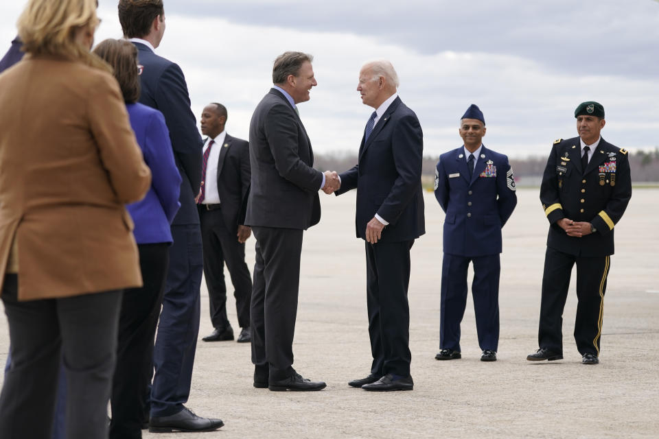 President Joe Biden speaks with New Hampshire Governor Chris Sununu after stepping off Air Force One at Portsmouth International Airport at Pease in Portsmouth, N.H., Tuesday, April 19, 2022. Biden is in New Hampshire to promote his infrastructure agenda. (AP Photo/Patrick Semansky)