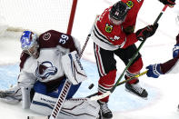 Colorado Avalanche goaltender Pavel Francouz, left, stops a shot by Chicago Blackhawks center Sam Lafferty during the third period of an NHL hockey game in Chicago, Friday, Jan. 28, 2022. (AP Photo/Nam Y. Huh)
