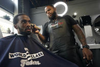 Barber Dwayne Speed gives a haircut to Artis White at World Class Faders (Barbershop) in Sacramento, Calif., Wednesday, July 28, 2021. Speed is a registered Democrat who says he is unsure how he'll vote in the Sept. 14 recall election against Democratic Gov. Gavin Newsom. (AP Photo/Rich Pedroncelli))