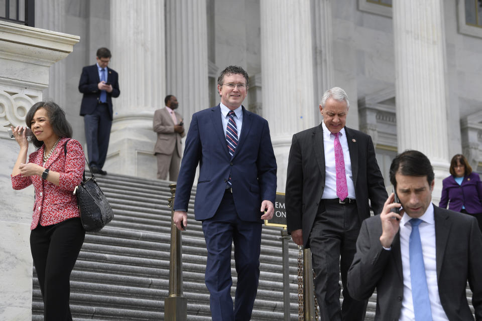 Rep. Thomas Massie, R-Ky., center, walks with Rep. Ken Buck, R-Colo., pink tie, as they leave Capitol Hill in Washington, Friday, March 27, 2020, after attempting to slow action on a rescue package. Despite Massie's effort, the House, acting with exceptional resolve in an extraordinary time, rushed President Donald Trump a $2.2 trillion rescue package Friday, tossing a life preserver to a U.S. economy and health care system left flailing by the coronavirus pandemic. (AP Photo/Susan Walsh)