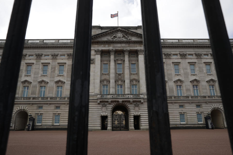 Buckingham Palace, the official London residence of Britain's Queen Elizabeth II is seen through the rails of its fence in central London, Sunday, March 7, 2021. The time has finally come for audiences to hear Meghan and Harry describe the backstory and effects of their tumultuous split from royal life. British audiences will wake up Monday to headlines and social media posts about Oprah Winfrey's 8 p.m. Sunday U.S. Eastern time interview, but won't be able to see the full interview until Monday night when it airs on ITV. (AP Photo/Matt Dunham)