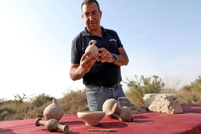 <div class="inline-image__title">1236597566</div> <div class="inline-image__caption"><p>Israel Antiquities Authority (IAA) archaeologist Saar Ganor presents pottery finds at an excavation site in Lachish Forest near the southern city of Kiryat Gat on Nov. 16, 2021. Hellenistic fortified structure destroyed and burned by Hasmoneans was uncovered during an IAA excavation. “The building’s devastation is probably related to the region’s conquest by the Hasmonean leader John Hyrcanus in around 112 BCE,” according to IAA archaeologists.</p></div> <div class="inline-image__credit">Gil Cohen-Magen/AFP via Getty Images</div>