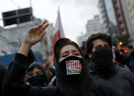 A student holds up a sign during a protest against cuts to federal spending on higher education planned by Brazil's President Jair Bolsonaro's right-wing government, in Sao Paulo, Brazil May 15, 2019. The sign reads: "Bolsonaro out" REUTERS/Nacho Doce