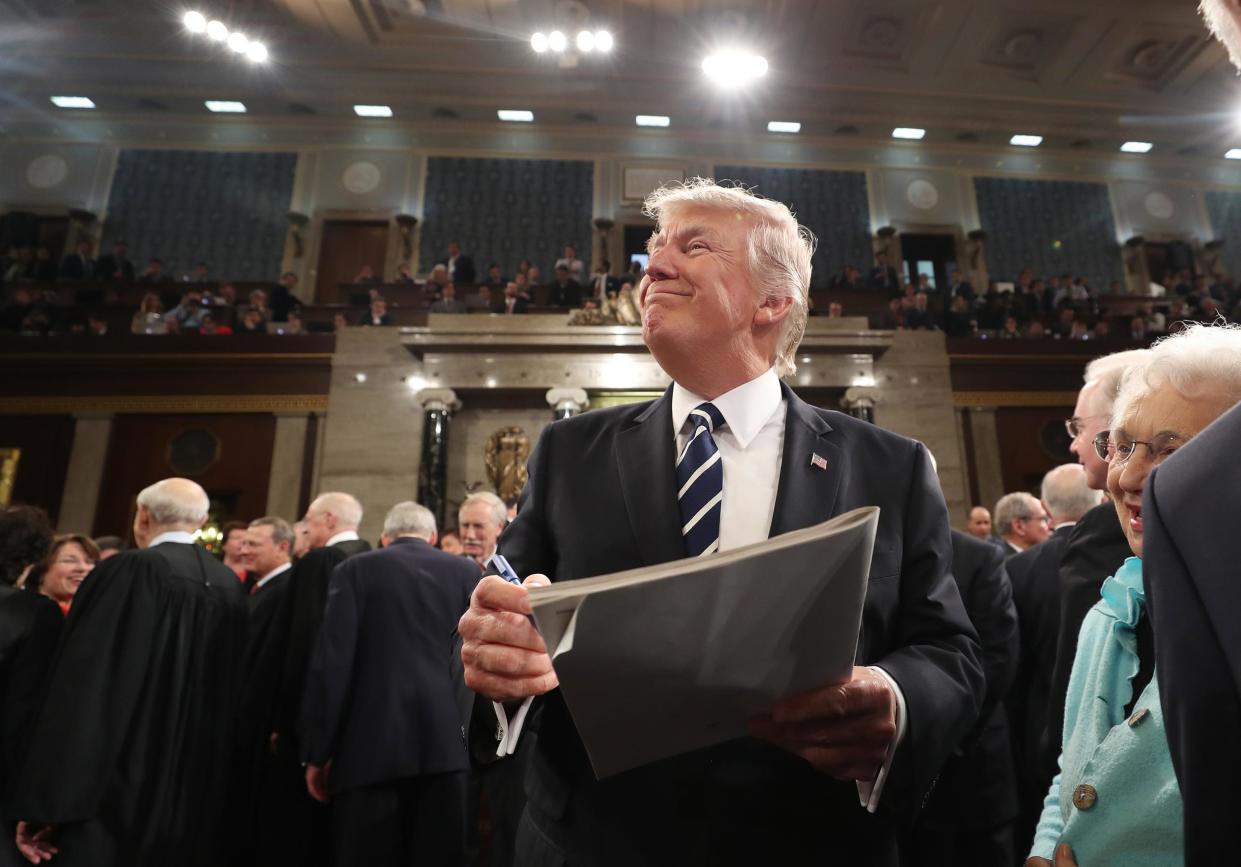 US President Donald Trump signs an autograph on his way out after delivering his first address to a joint session of Congress: Getty Images