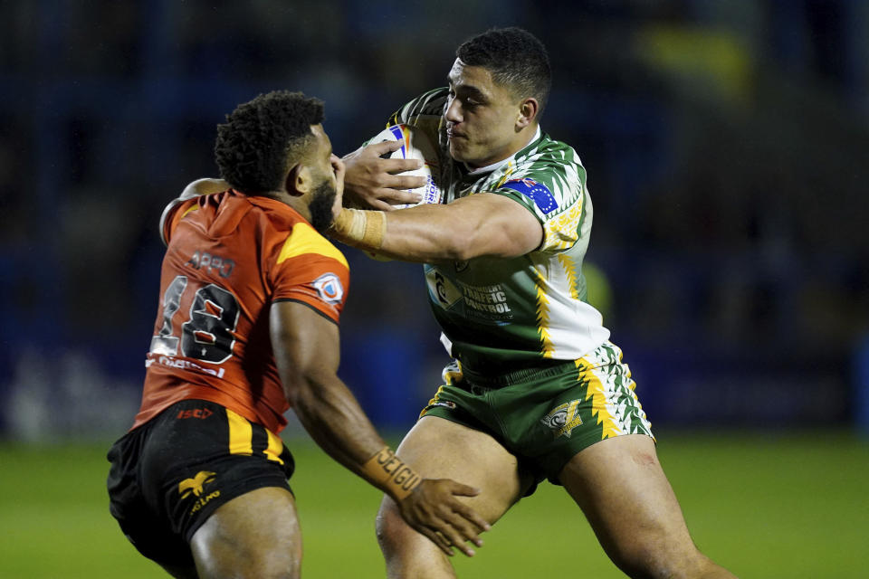 Cook Islands' Davvy Moale and Papua New Guinea's Kevan Appo in action during the Rugby League World Cup group D match between Papua New Guinea and Cook Islands at The Halliwell Jones Stadium, Warrington, England, Tuesday Oct. 25, 2022. (Mike Egerton/PA via AP)