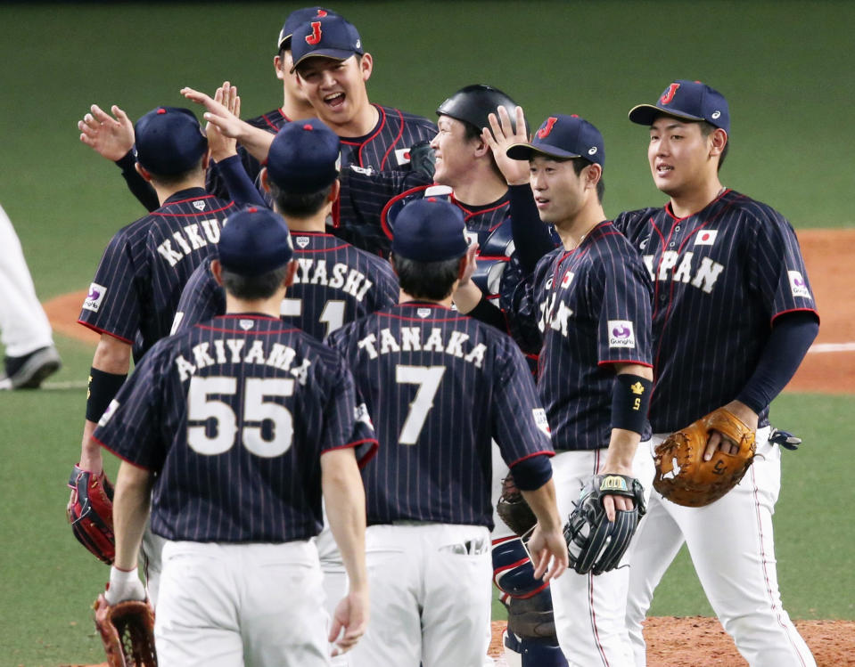 All Japan closer Yasuaki Yamasaki, back facing camera, celebrates with teammates on the mound after beating MLB All-Stars 4-1 in Game 6 at their All-Stars Series baseball at Nagoya Dome in Nagoya, central Japan, Thursday, Nov. 15, 2018. Japan improved to 5-1 in the series. (Kyodo News via AP)