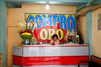 A girl is seen inside a shop which buys gold from miners in La Rinconada, in the Andes