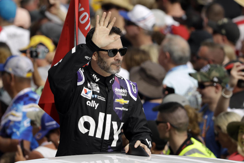 Jimmie Johnson waves to fans during driver introductions before the NASCAR Daytona 500 auto race Sunday, Feb. 16, 2020, at Daytona International Speedway in Daytona Beach, Fla. Johnson is making his last Daytona 500 start. (AP Photo/Chris O'Meara)