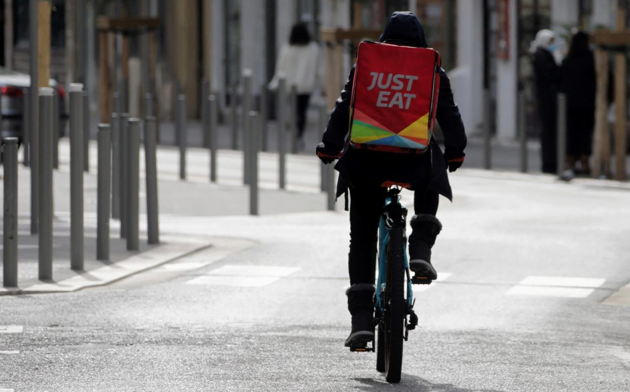 FILE PHOTO: A Just Eat delivery man rides his bicycle in Nice amid the coronavirus disease (COVID-19) outbreak in France, February 16, 2021. REUTERS/Eric Gaillard/File Photo - ERIC GAILLARD/REUTERS