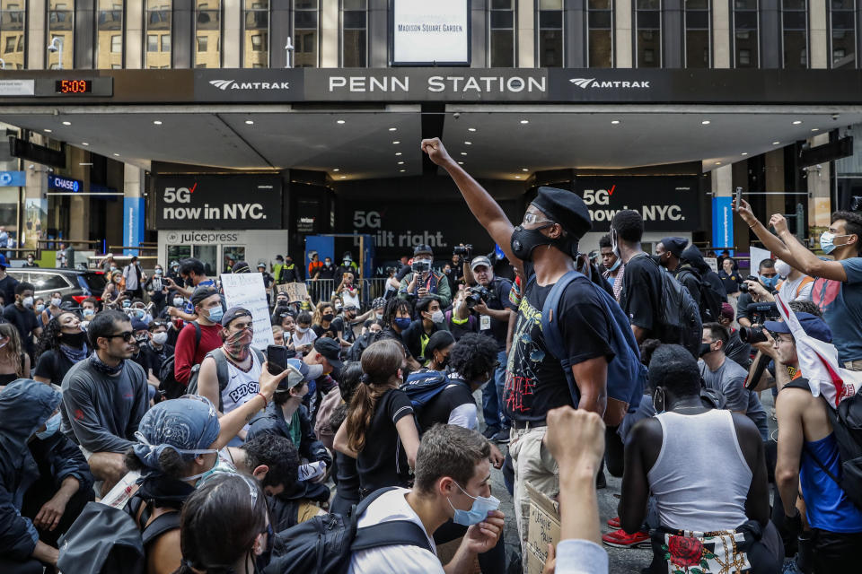 Protesters take a knee before a moment of silence outside Pennsylvania Station and Madison Square Garden during a march, Wednesday, June 3, 2020, in the Manhattan borough of New York. Protests continued following the death of George Floyd, who died after being restrained by Minneapolis police officers on Memorial Day. (AP Photo/John Minchillo)