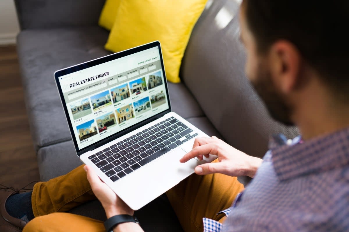 Man using computer to look up houses