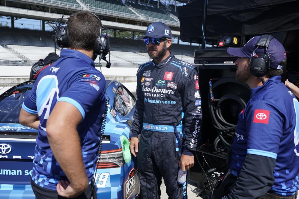 Martin Truex Jr. talks with his crew during a practice session for the NASCAR Cup Series auto race at Indianapolis Motor Speedway, Saturday, Aug. 12, 2023, in Indianapolis. (AP Photo/Darron Cummings)