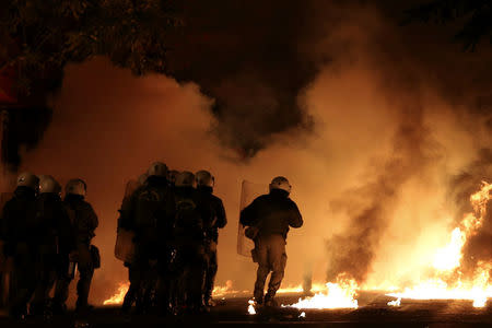 Riot police run through flames caused by petrol bombs during clashes following an anniversary rally marking the 2008 police shooting of 15-year-old student, Alexandros Grigoropoulos, in Athens, Greece, December 6, 2016. REUTERS/Alkis Konstantinidis