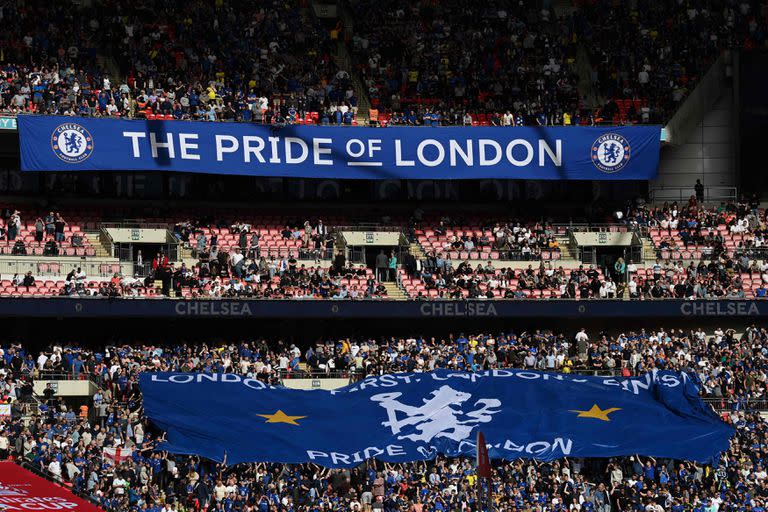 (FILES) In this file photo taken on April 17, 2022, Chelsea supporters display a large flag as they build the atmosphere ahead of the English FA Cup semi-final football match between Chelsea and Crystal Palace at Wembley Stadium in north west London. - Chelsea FC said on May 6, 2022 a group led by Los Angeles Dodgers co-owner Todd Boehly would acquire the London club after agreeing terms in a deal worth £4.25 billion (USD 5.2 billion). (Photo by Glyn KIRK / AFP) / NOT FOR MARKETING OR ADVERTISING USE / RESTRICTED TO EDITORIAL USE