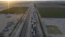Trucks line up as farmworkers block the Pan-American highway during a protest in Villacuri, Ica province, Peru, Wednesday, Dec. 2, 2020. The workers are demanding better wages and health benefits. (AP Photo/Rodrigo Abd)
