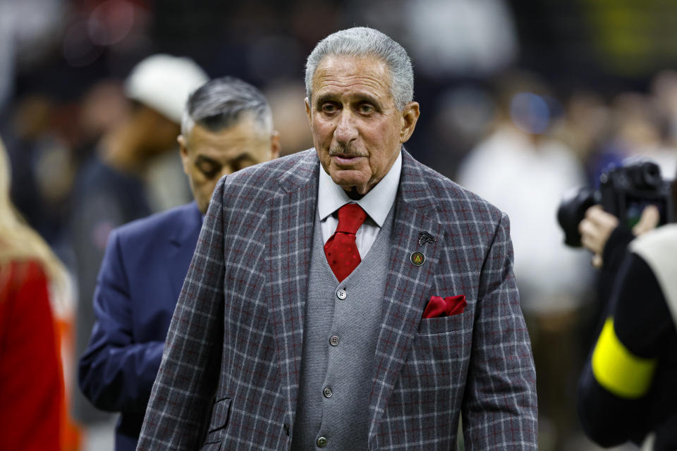 FILE -Atlanta Falcons owner Arthur Blank walks onto the field before an NFL football game between the Atlanta Falcons and New Orleans Saints in New Orleans, Sunday, Dec. 18, 2022. Atlanta Falcons owner Arthur Blank said Wednesday, Feb. 8, 2023 he is encouraged by the progress of quarterback Desmond Ridder and the potential of building the team around the rookie.(AP Photo/Butch Dill, File)