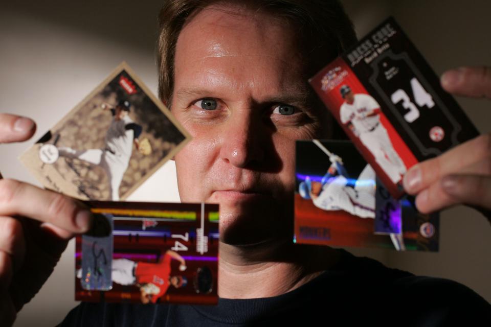 In this 2005 photo, Mike Mittrick displays baseball trading cards in his 52 Mantle Card store in Brea, California.