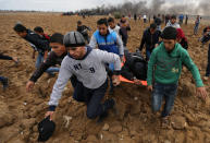 <p>A wounded Palestinian protester is evacuated during clashes with Israeli troops at a protest against President Donald Trump’s decision to recognize Jerusalem as the capital of Israel, near the border with Israel in the southern Gaza Strip, Dec. 7, 2017. (Photo: Ibraheem Abu Mustafa/Reuters) </p>