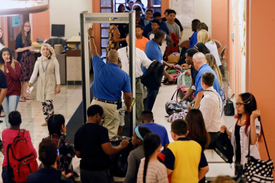 Students at William Hackett Middle School have their bags checked and pass through metal detectors on the first day of school, nearly 20 years since the Columbine school massacre. (AP)
