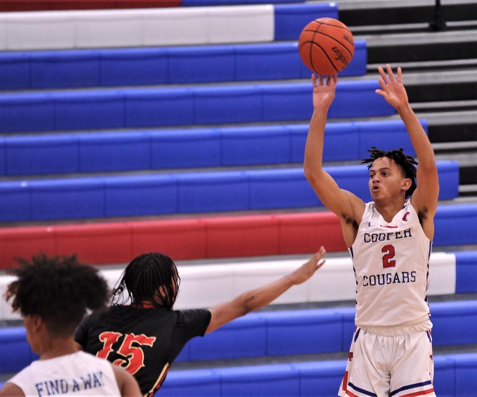 Cooper's Colin Reed (2) shoots a 3-point goal as Lubbock Coronado's Tyler Williams (15) defends in the first half.