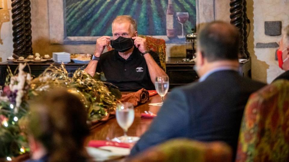 Sen. Thom Tillis demonstrates both effective and ineffective ways to wear a face covering while leading a roundtable discussion on the Paycheck Protection Program with members of the restaurant and hospitality industry Tuesday, Aug. 25, 2020 at the Angus Barn in Raleigh. Tillis says he has been a proponent of wearing face masks since the CDC recommended the practice in April.