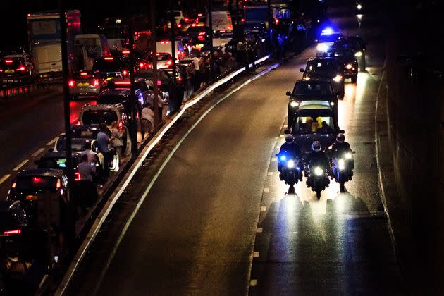 People get out of their cars to watch as the hearse carrying the coffin of Queen Elizabeth II passes along the A40 in west London. (Photo: Victoria Jones - PA Images via Getty Images)