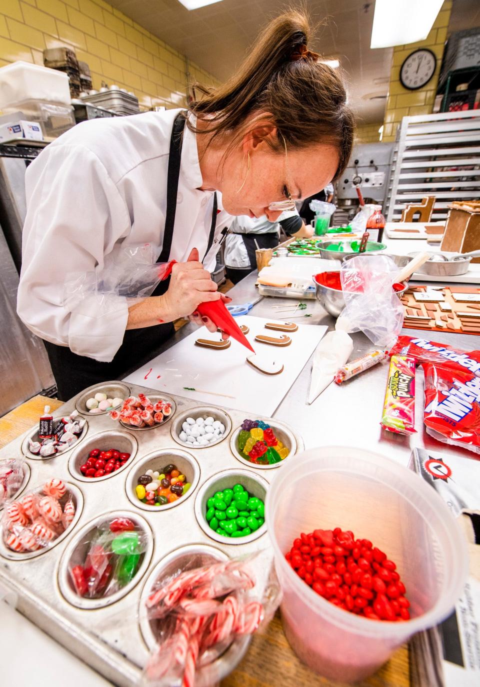 Chef Hayden Kemerly works on making gingerbread candy canes for a Indiana University themed gingerbread scene at the Indiana Memorial Union on Tuesday, Nov. 29, 2022.