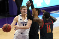 Northwestern forward Miller Kopp, left, looks to pass the ball as Maryland guard Hakim Hart, center, and guard Darryl Morsell defend during the second half of an NCAA college basketball game in Evanston, Ill., Wednesday, March 3, 2021. (AP Photo/Nam Y. Huh)