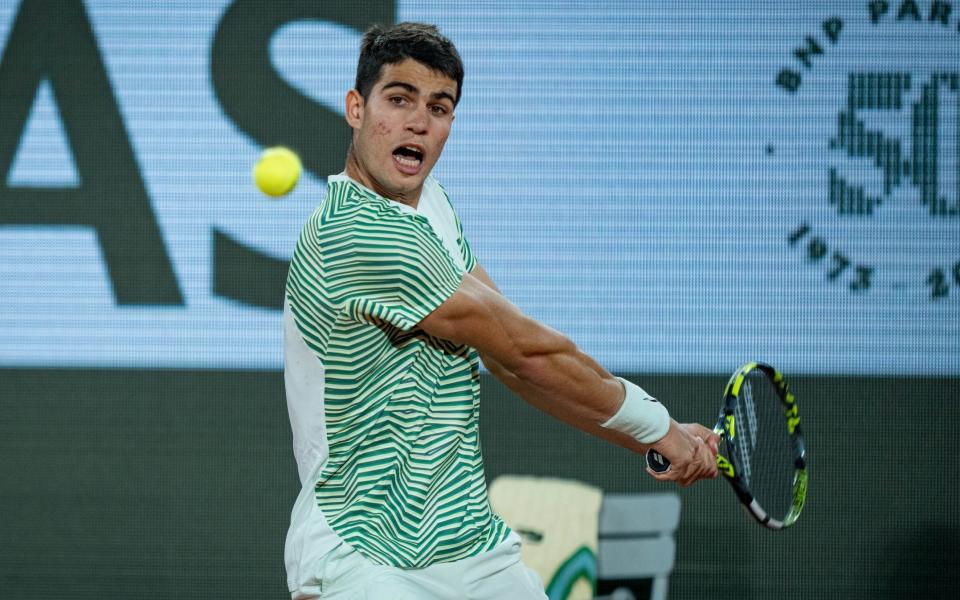 Carlos Alcaraz of Spain plays a backhand during the Men's Singles Quarter Final Round Match against Stefanos Tsitsipas of Greece during Day 10 of the French Open at Roland Garros on June 6, 2023 in Paris, France - Getty Images/Andy Cheung