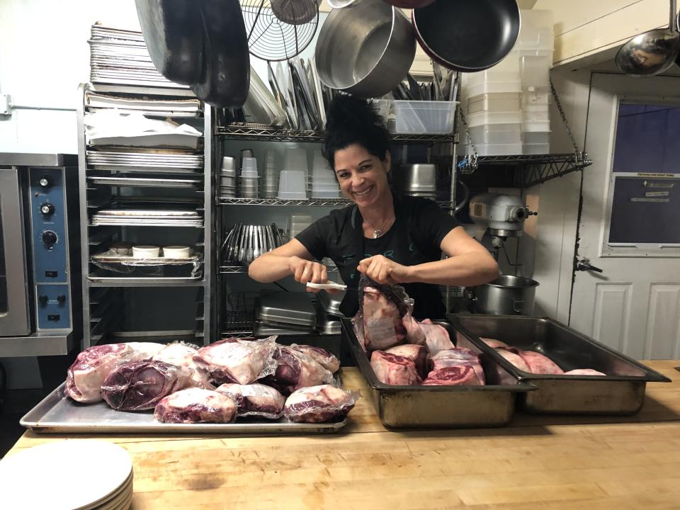 Chef Sarah Piccolo preparing meats at her restaurant Fork Roadhouse