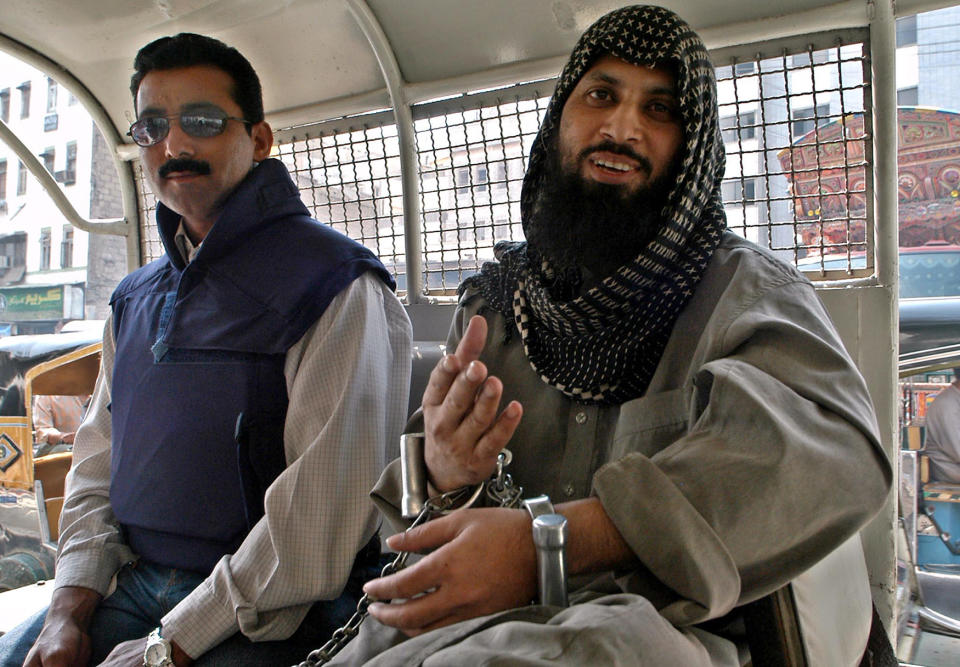 <p>Pakistani suspected Islamic militant Mohammed Sohail, right, is accompanied by unidentified police officer, left, while leaving a court in Karachi, Pakistan on Monday, March 7, 2005. Sohail, who is in police custody in the slaying of Wall Street Journal reporter Daniel Pearl is not cooperating with interrogators, an official said. (AP Photo/Shakil Adil) </p>