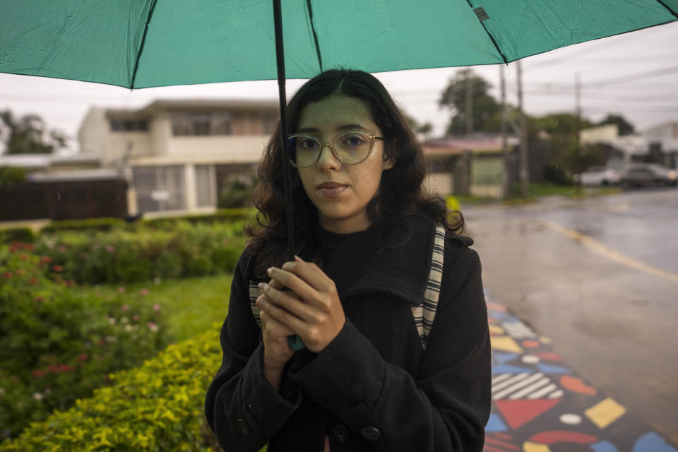 Nicaraguan asylum-seeker Katherine Ramirez poses for a portrait as she walks to the bus stop on her way home from work in San Jose, Costa Rica, Tuesday, Aug. 23, 2022. The 23-year-old who left Nicaragua in March and became a student leader among Nicaraguan students in exile, is hoping to continue her political science education in Costa Rica. (AP Photo/Moises Castillo)