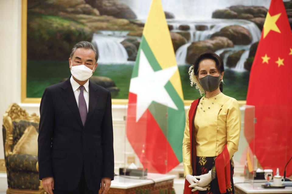 Myanmar's leader Aung San Suu Kyi, right, and Chinese Foreign Minister Wang Yi, left, pose for photo, during their meeting at the President House in Naypyitaw, Myanmar, Monday, Jan. 11, 2021. Foreign Minister Wang is on a tour this week of Southeast Asia countries that includes visits to Myanmar, Indonesia, Brunei and the Philippines to promote China's relations in the region. (Myanmar President Office via AP)