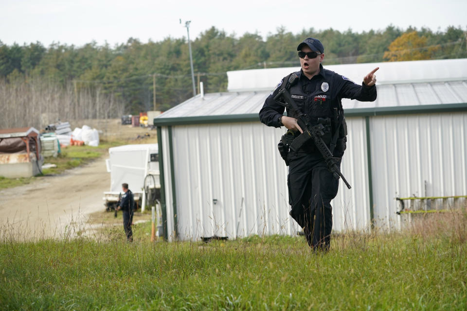 FILE - A police officer gives an order to the public during a manhunt at a farm for the suspect in recent deadly mass shootings, Oct. 27, 2023, in Lisbon, Maine. Voters in Maine’s 2nd Congressional District will consider the political future of three-term Rep. Jared Golden in one of the nation’s most closely watched congressional elections. Golden is a Democrat with a history of supporting gun rights who has long bucked his party on the issue. Golden, a Marine veteran of two wars, has shifted on the issue of guns since the Lewiston mass shootings and now supports an assault weapons ban. (AP Photo/Robert F. Bukaty, File)