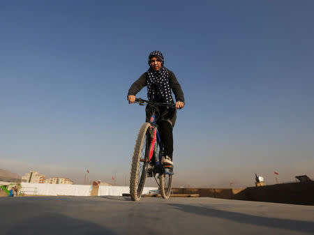 An Afghan young cyclist performs her tactics during an exercise in Kabul, Afghanistan November 15, 2016. REUTERS/Omar Sobhani