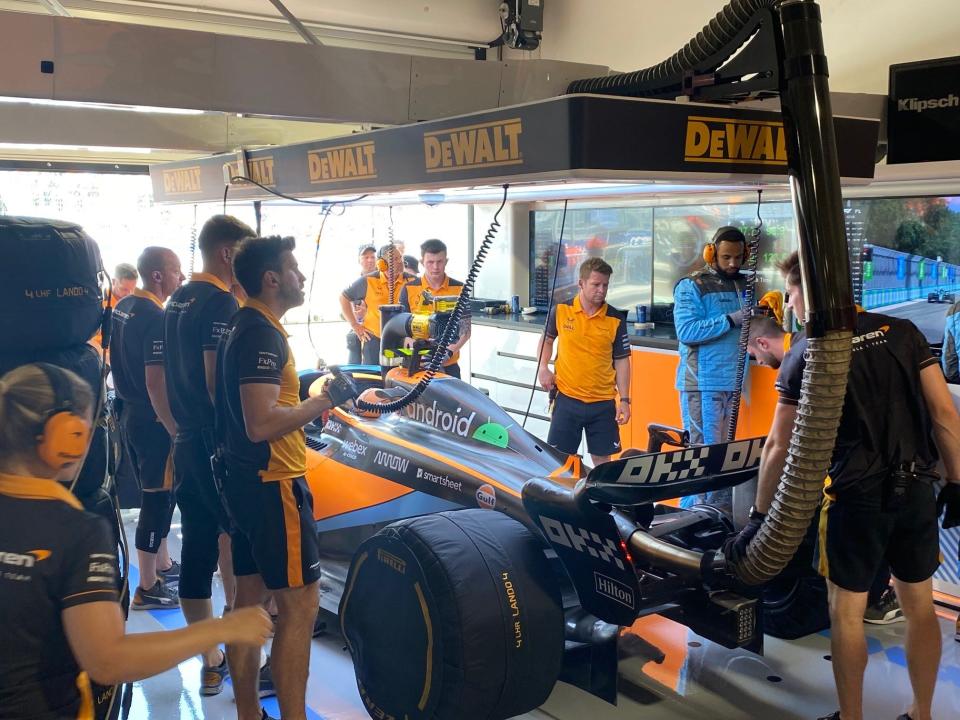 The McLaren F1 team works on Lando Norris's car during the first practice of the Miami Grand Prix.