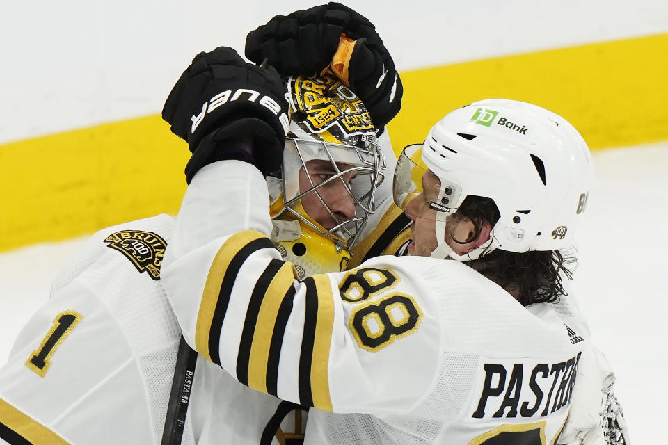 Boston Bruins goaltender Jeremy Swayman (1) and David Pastrnak (88) celebrate after defeating the Toronto Maple Leafs in Game 3 of an NHL hockey Stanley Cup first-round playoff series in Toronto on Wednesday, April 24, 2024. (Frank Gunn/The Canadian Press via AP)