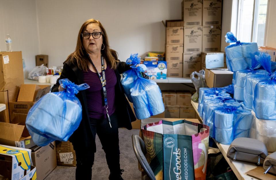 A volunteer carries supplies to be delivered to snow-bound residents in the San Bernardino Mountains