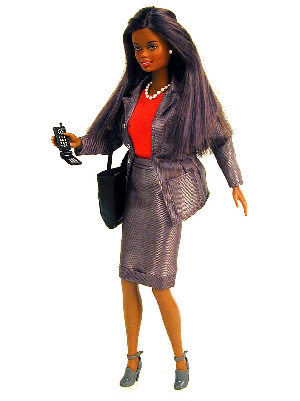 Mattel's Working Woman Barbie doll in a business suit with a cellphone.