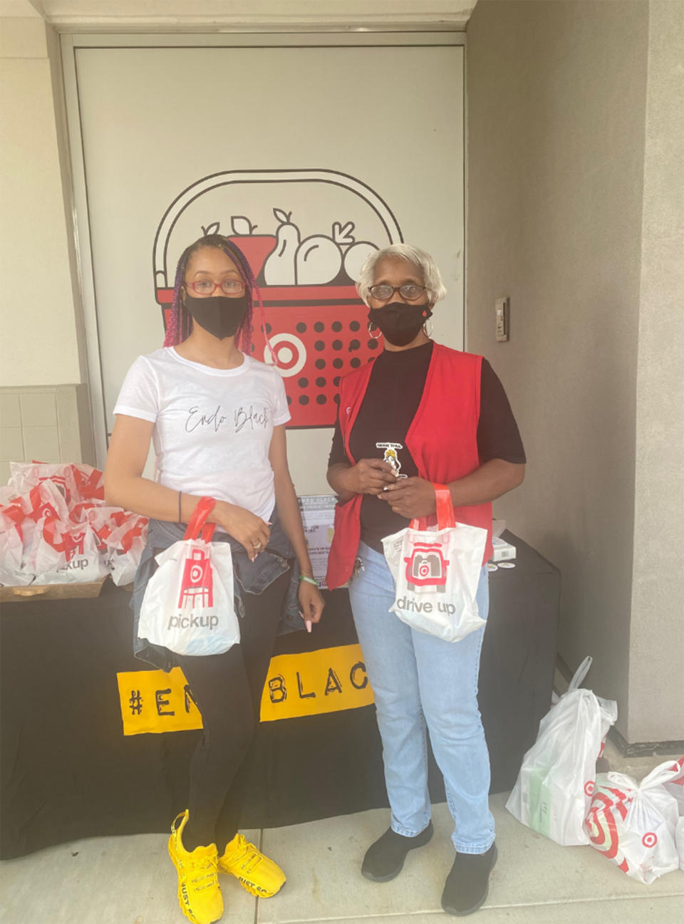 Lauren Kornegay, founder and executive Director of Endo Black, Inc., poses with a Target manager as she receives donations of hygiene products and non-toxic period care items for the Period Care Initiative. (Courtesy Lauren Kornegay)