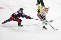 Columbus Blue Jackets Oliver Bjorkstrand, left, tries to stop Nashville Predators Erik Haula on a breakaway during the first period of an NHL hockey game Monday, May 3, 2021, in Columbus, Ohio. (AP Photo/Jay LaPrete)
